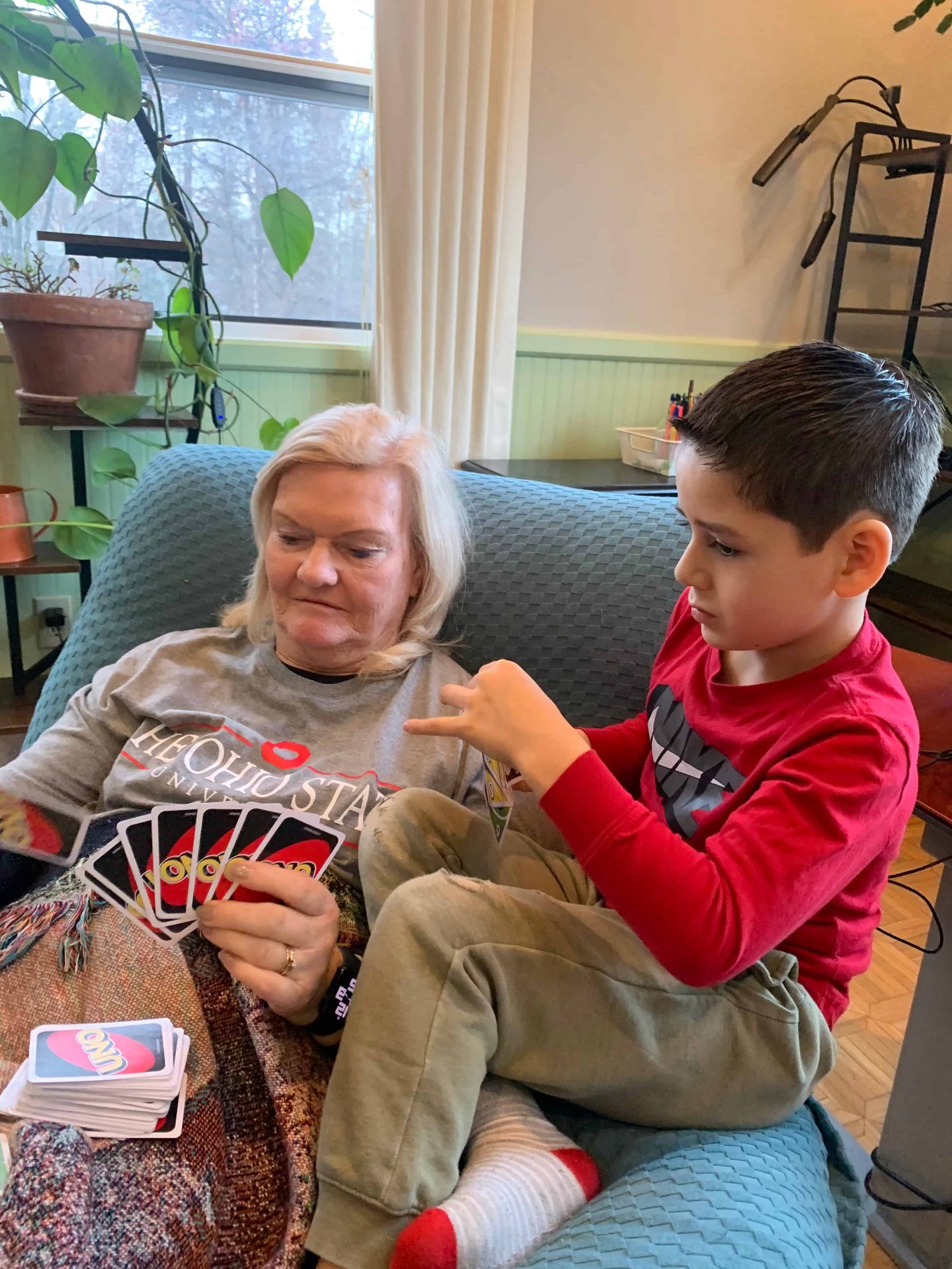 Grandmother and grandson playing cards together